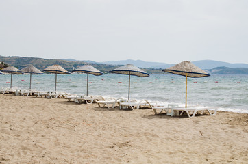 Rows of empty sun loungers and umbrellas on the beach. Camel Beach in Turkey.
