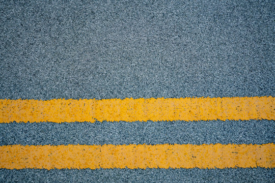 Road Marking - Two Yellow Stripes On Gray Asphalt Fragment