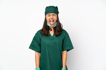 Surgeon woman in green uniform isolated on white background shouting to the front with mouth wide open