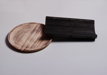 Wooden plate with a wooden tile on white background