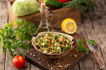 Healthy salad with mung beans, tomatoes, cucumber, lettuce and greens