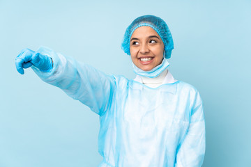 Young surgeon Indian woman in blue uniform giving a thumbs up gesture