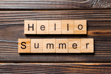 Hello Summer word written on wood block. Hello Summer text on wooden table for your desing, concept