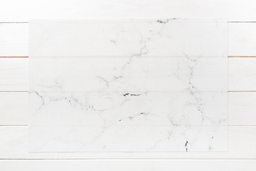 Top view of white place mat for a dish. Wooden background with empty space for your design