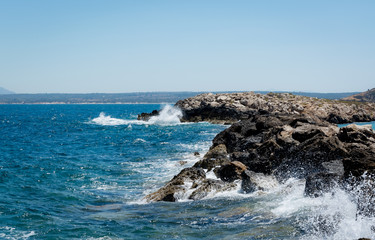 Coastline with waves clatters against rocks blue sea greece Kos