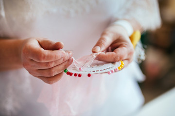Woman seamstress holds in her hands a lot of needles