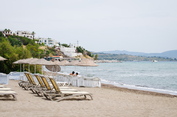 Rows of empty sun loungers and umbrellas on the beach. Camel Beach in Turkey.