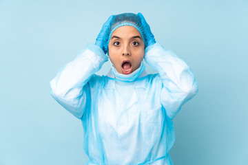 Young surgeon Indian woman in blue uniform with surprise expression