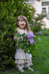 little girl with a bouquet of wild flowers.  girl with flowers. portrait of a girl in garden