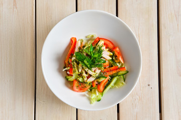 Top view of salad with fresh tomato, cucumber and boiled chicken fillet