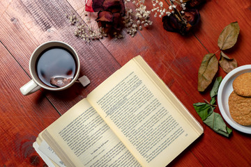 old book and glasses on the wood background