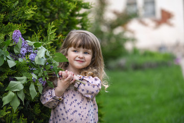 little girl with a bouquet of wild flowers.  girl with flowers. portrait of a girl in garden