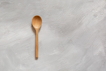 Wooden spoons made of wood on a gray background. Eco-friendly dishes.