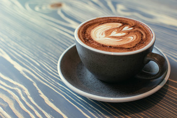 A glass of coffee with milk foam