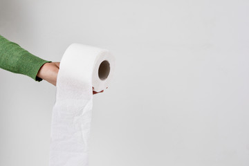 toilet paper shortage concept. Woman holding toilet paper roll.