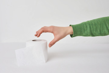 Woman holds a roll of tissue in hands on a white background. Concept of Covid-19 quarantine.Doomsday panic people panic.