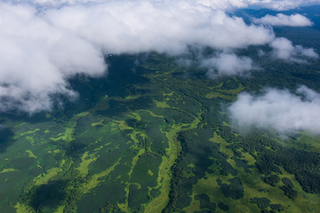 Fototapeta premium aerial view of Kamchatka volcanos, green valleys, snow and ice and the wonderful view of pure nature.