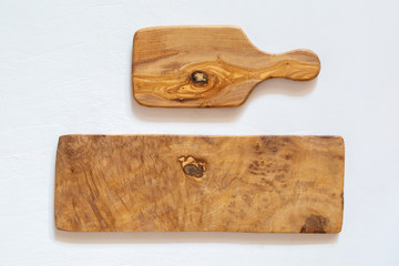 Kitchen boards made of natural olive wood on a white background. Eco-friendly dishes.