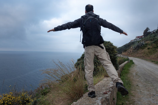 Man on one foot climbed on a wall