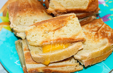 Hot toast with melted cheese for Breakfast made in a sandwich maker at home.