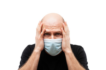 Young adult bald head man wearing respiratory protective medical mask