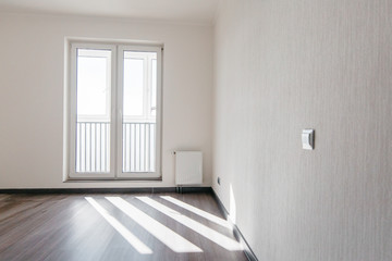 sun rays in the window in an empty room with a new renovation