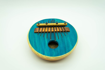 Blue African Kalimba on a white background in the centre of the image. Traditional music concept
