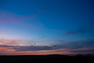 A photo of the horizon taken during the blue hour. Beautiful clouds