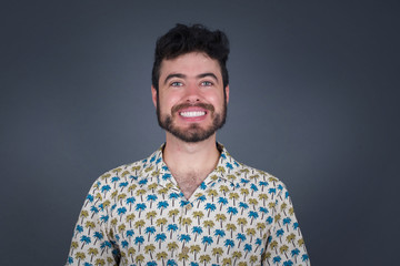 Horizontal portrait of pleasant-looking Caucasian male wearing casual clothes looking happily to the camera.