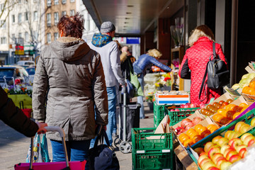 Selected focus, European people queue outside in front of food stall and supermarket during...