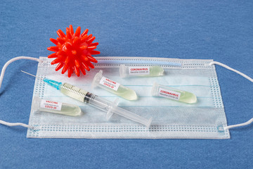 Test tube with blood sample Covid-19 (coronavirus). Laboratory testing blood. Vaccine and syringe...