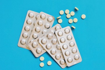 Blister packed tablets on a blue background