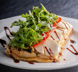 fried pancake with mozzarella, tomatoes and arugula