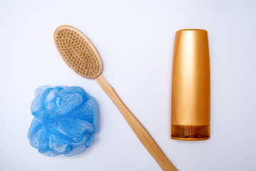 Bath, shower accessories on white background, shower gel, body wash, wooden brush and a sponge