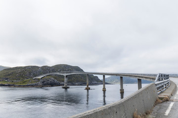 bridge over the water connecting an island to a Norwegian fjord