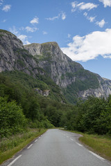 empty roads that run through spectacular landscapes, roads near the northern fjords, incredible mountains, snowy peaks, abundant vegetation
