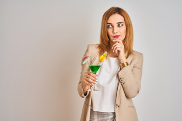 Redhead caucasian business woman drinking a summer cocktail over isolated background serious face...