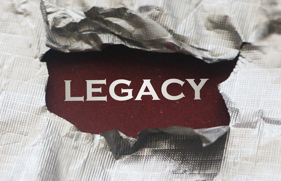 Legacy silver word under torn foil paper. Legacy or law or jugdement concept