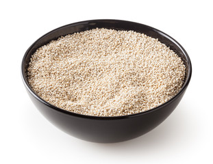 Dried white quinoa seeds in black bowl isolated on white background with clipping path
