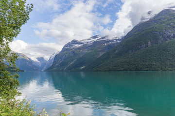 Naklejka na ściany i meble landscape of a turquoise water fjord between mountains in Norway