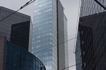 Obraz premium Cityscape with fragments of tall buildings in blue and gray colors
