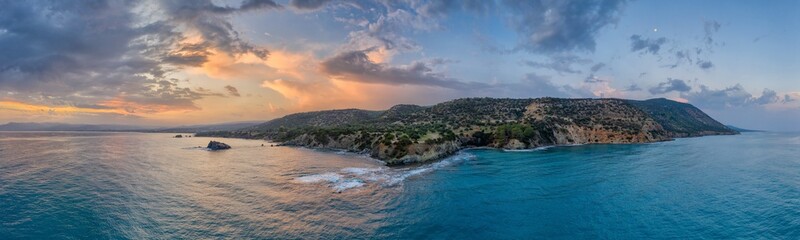 Fototapeta premium Great panoramic landscape of Cyprus island. Aerial view. Cloudy sky and colorful Mediterranean sea. Forest, mountains and a rocky shore.