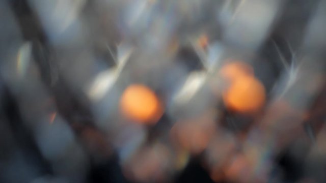 Colored bokeh in pastel colors on a dark background. Moving abstract background.