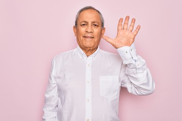 Senior handsome grey-haired man wearing elegant shirt over isolated pink background showing and pointing up with fingers number five while smiling confident and happy.