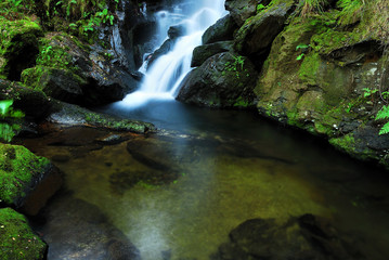 Fototapeta na wymiar small waterfall in river