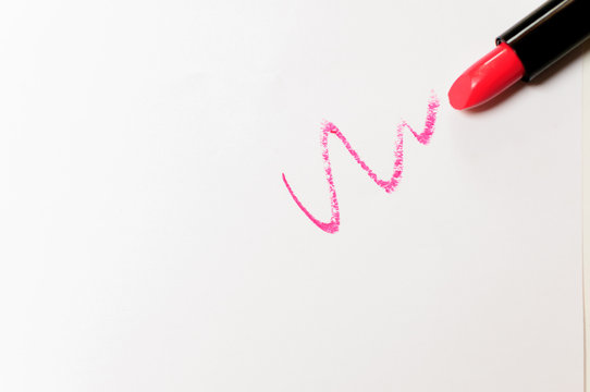 Red lipstick with trace over white background.