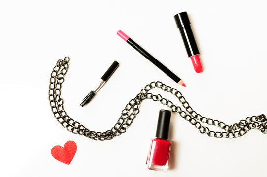 Make up cosmetic bag with professional accessories. Lipsticks and brushes in a black cosmetic bag in white background
