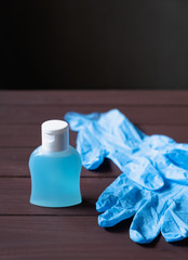 medical latex gloves, a bottle of antiseptic liquid on a brown background against the new coronavirus or coronavirus
