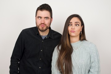 Funny comic girl crosses eyes, puts lips, makes grimace, foolishes after all day studying. Clueless woman nerd with awkward expression has fun alone, plays fool.