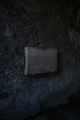 old roman script on a stone sign made many years ago